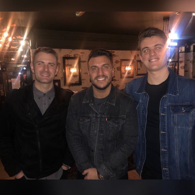 George Berryman standing with two other people in a posed event photograph.