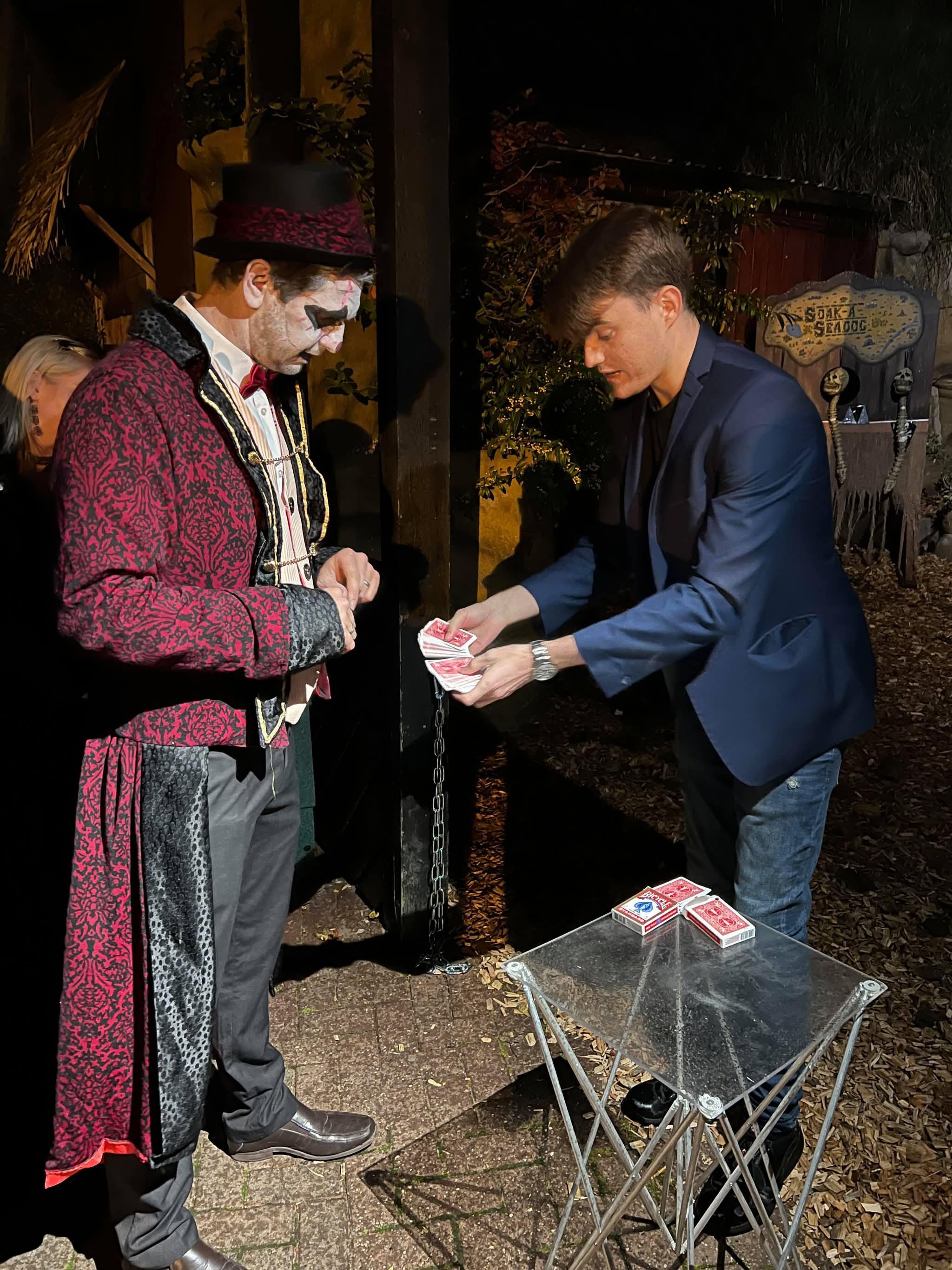 George Berryman performing close-up magic for a guest at a private themed event.
